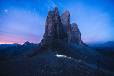 Rock formations on landscape against sky at night