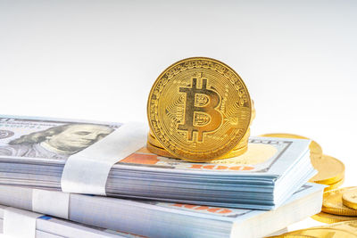 Close-up of coins on metal against white background