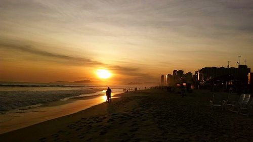 Scenic view of beach against sky during sunset