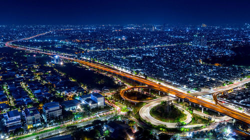 High angle view of illuminated city street at night