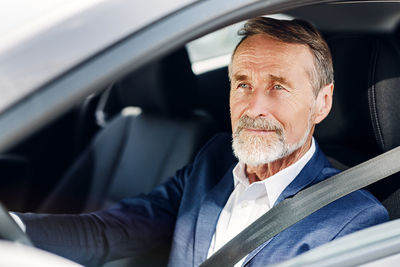 Portrait of man sitting in car