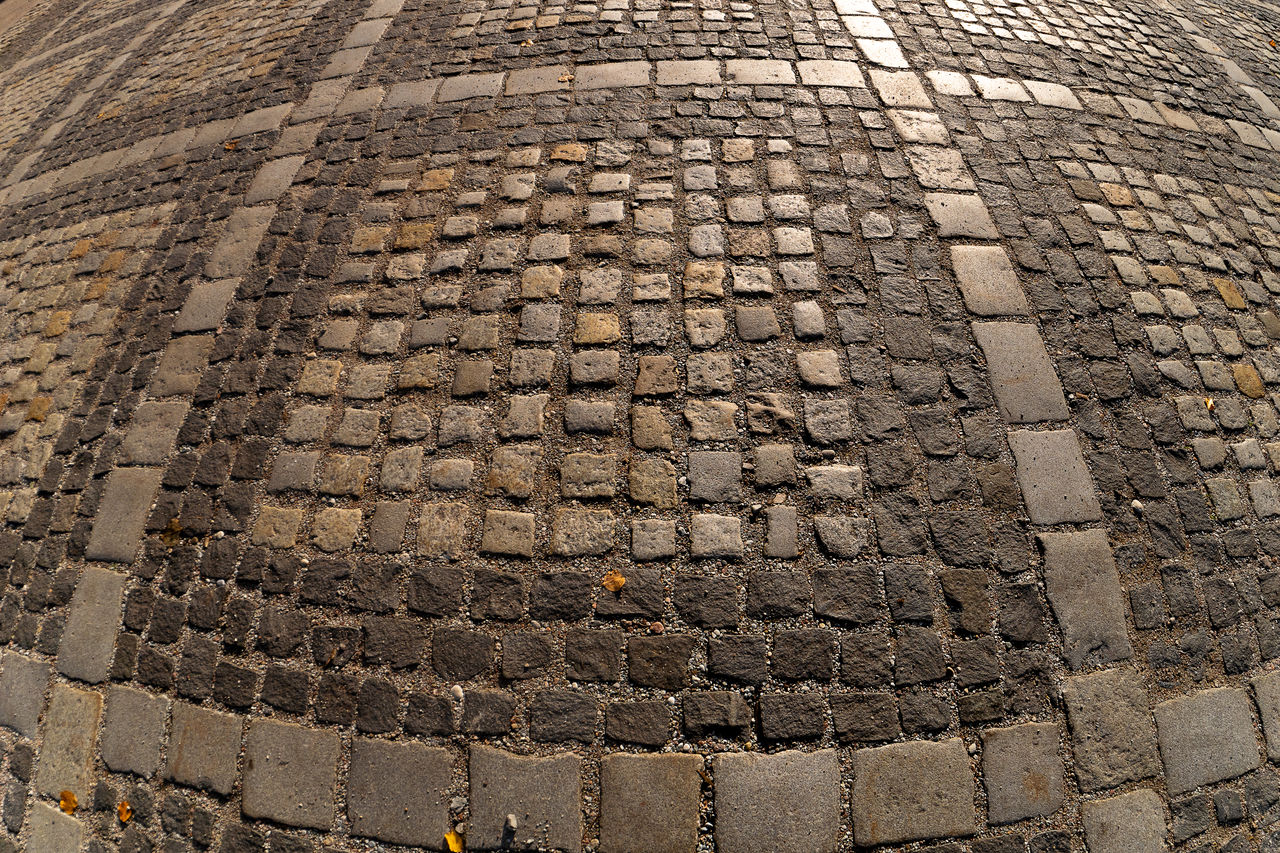 cobblestone, road surface, pattern, soil, no people, asphalt, street, day, high angle view, full frame, architecture, outdoors, textured, walkway, city, backgrounds, stone, footpath, brick, wall, nature, sunlight, flooring, stone material, history, ancient history, transportation, the past