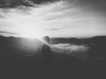 Silhouette man standing against sky