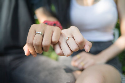 Midsection of couple showing wedding rings