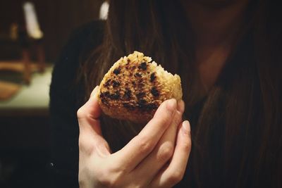 Midsection of woman holding onigiri