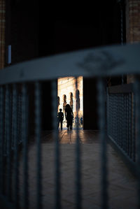 Silhouette people walking in corridor of building