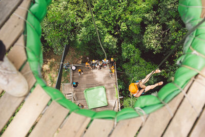 High angle view of woman rope climbing 