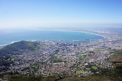 High angle view of townscape by sea against sky