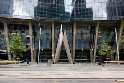 Footpath by street against buildings in city