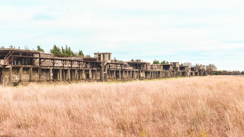 Built structure on field against sky