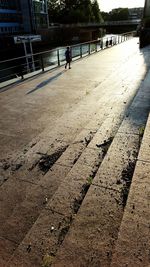 Shadow of person walking on railing