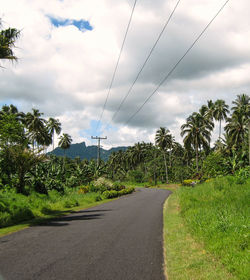 Road passing through landscape against cloudy sky