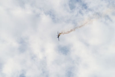 Low angle view of airplane flying against sky