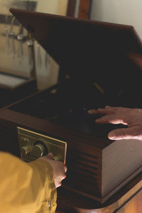 Cropped hands using audio equipment at home