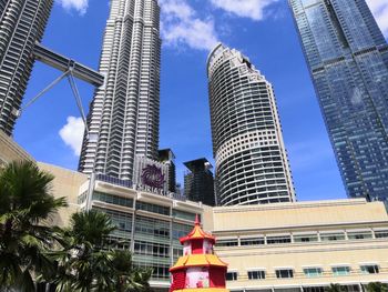 Low angle view of buildings against cloudy sky