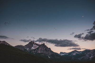 Scenic view of snowcapped mountains against sky during sunset