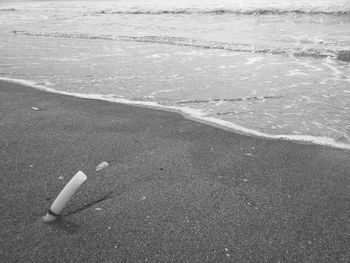 High angle view of cigarette on beach