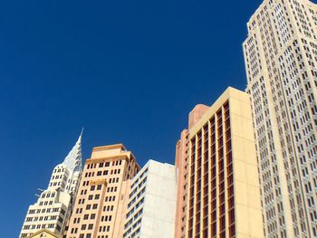 Low angle view of building against clear blue sky