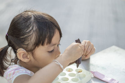 Close-up of cute girl with clay