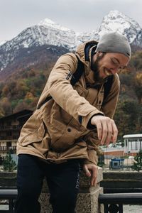 Midsection of man standing on mountain during winter