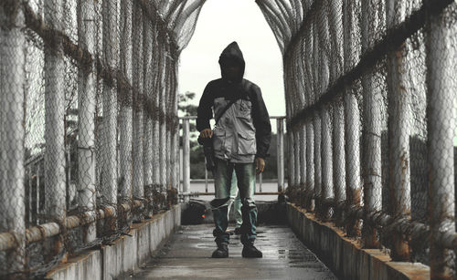 Full length of man standing on footbridge