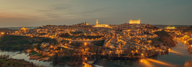 High angle view of buildings lit up at night