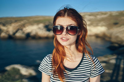 Portrait of smiling young woman wearing sunglasses