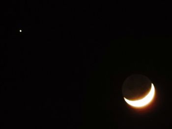 Low angle view of moon against sky at night