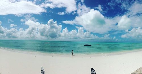 Scenic view of beach against cloudy sky