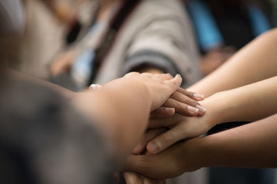 Close-up of friends stacking hands