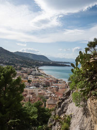 Townscape by sea against sky