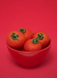 Close-up of tomatoes against red background