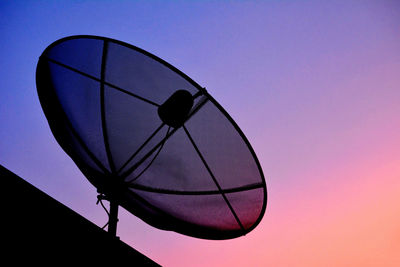 Low angle view of satellite dish against clear sky at dusk
