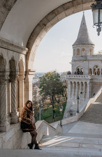 Young woman standing on steps at fisherman's bastion in budapest, hungary