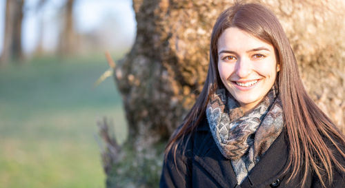 Portrait of young woman standing outdoors