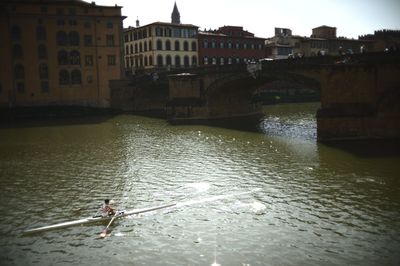 Bridge over river with buildings in background