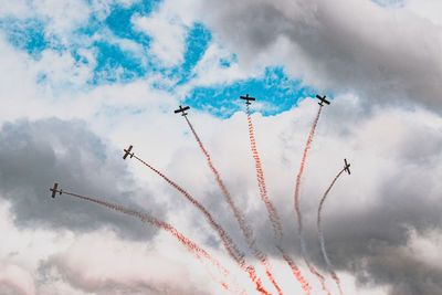 Low angle view of airplane flying against sky