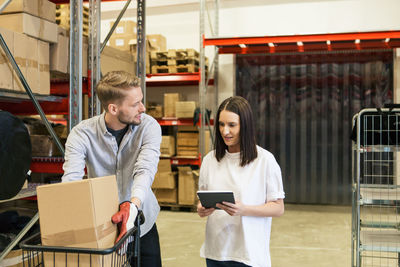 Male and female colleagues discussing together in industry