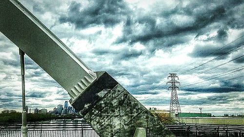 Low angle view of bridge against cloudy sky