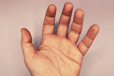 Close-up of hand against white background