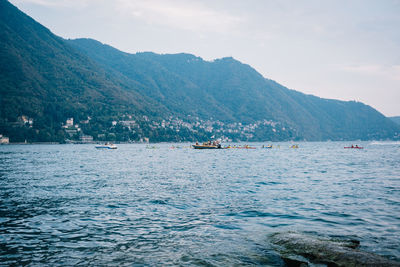 Scenic view of sea and mountains against sky