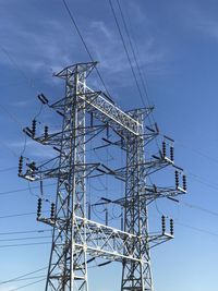Low angle view of electricity pylon against sky