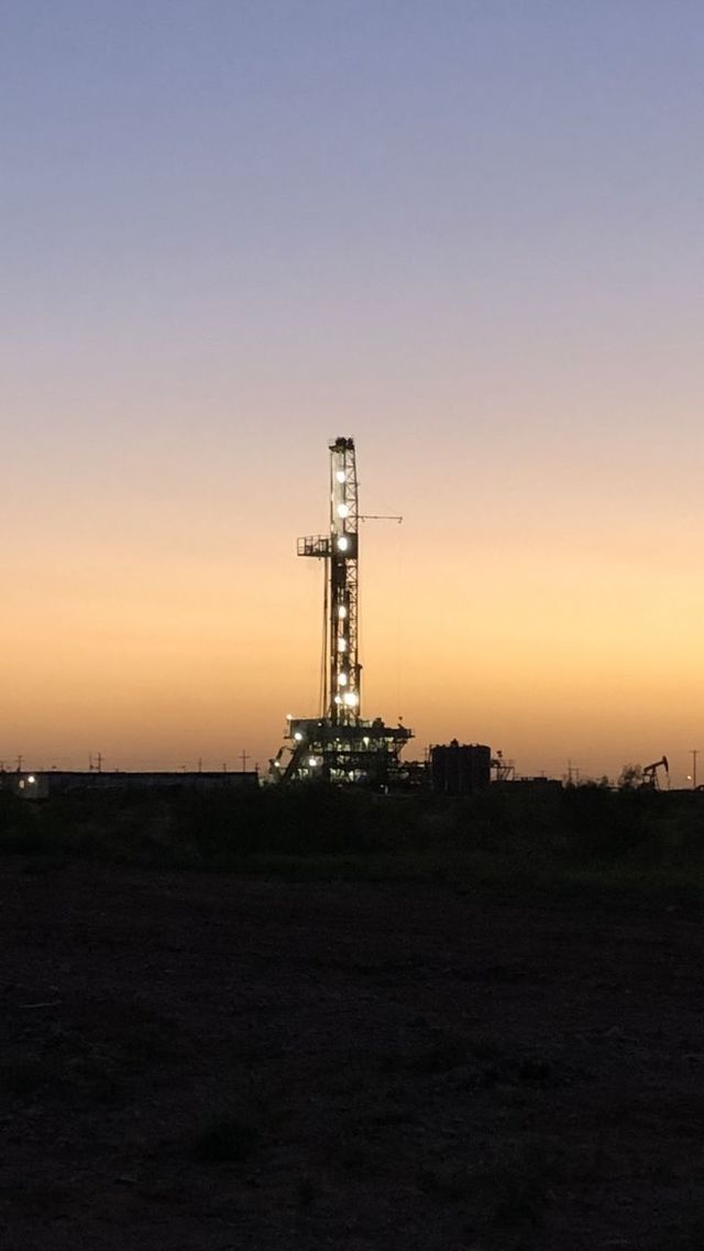 SILHOUETTE OF TOWER ON FIELD AGAINST SKY DURING SUNSET