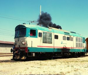 Train on railroad tracks against clear sky