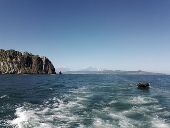 Scenic view of sea against clear blue sky