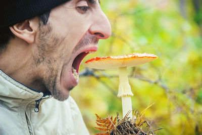 Close-up of man holding plant