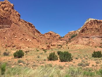 Scenic view of rocky mountains against clear blue sky