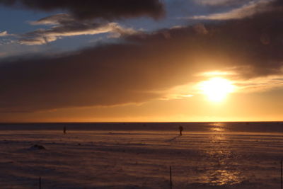 Scenic view of beach against sky during sunset