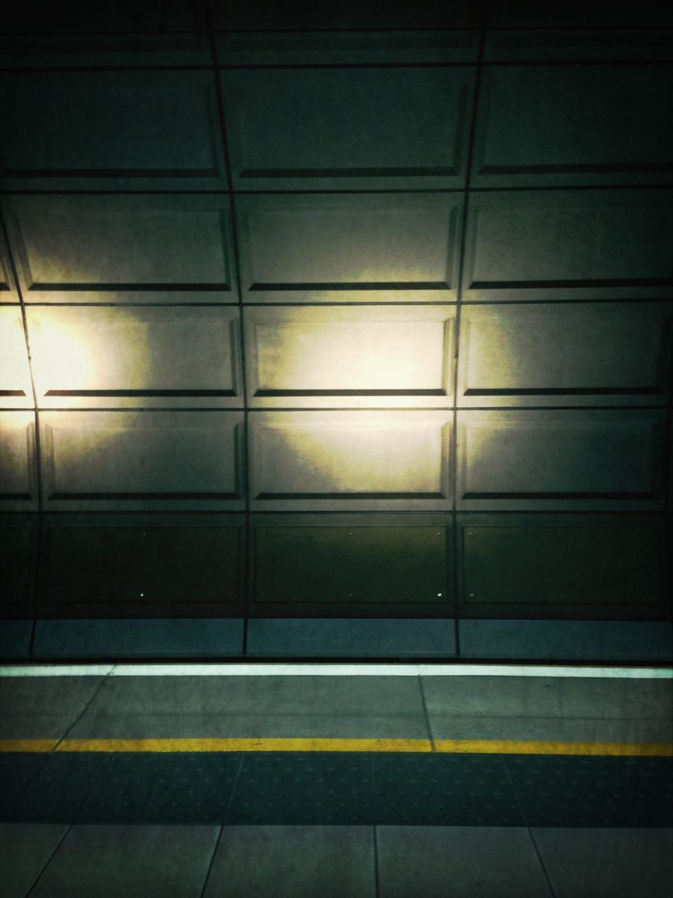 indoors, illuminated, built structure, architecture, pattern, tiled floor, wall - building feature, flooring, tile, empty, no people, sunlight, wall, window, night, railing, ceiling, geometric shape, building, shadow