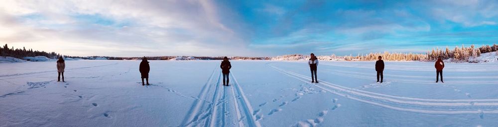 Panoramic view of snow covered field against sky